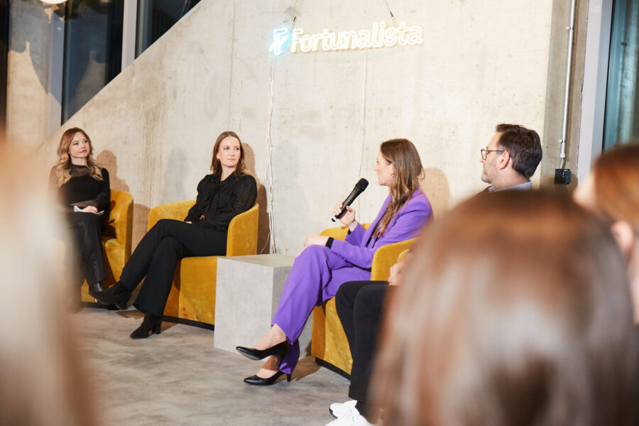 Eine Podiumsdiskussion bei einem Event. Eine Frau spricht ins Mikro.